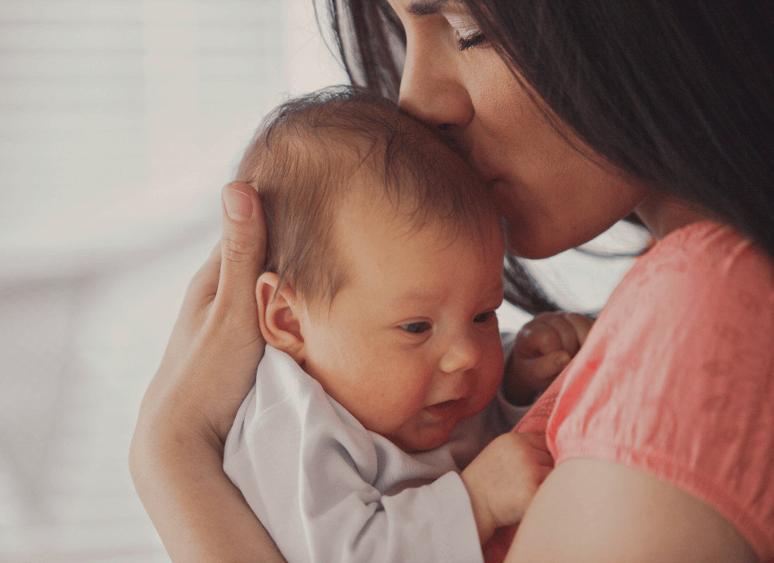 Mum kissing baby
