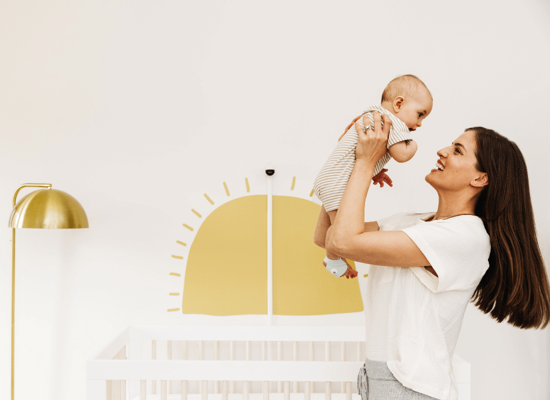 mum holding baby in air