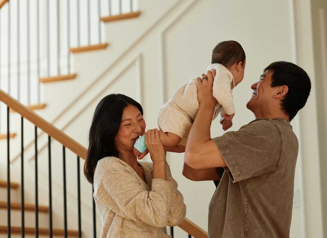 Parents holding up a baby