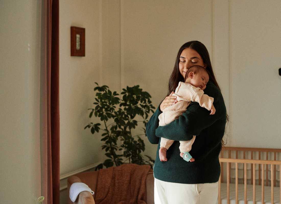 Mum holding sleeping baby