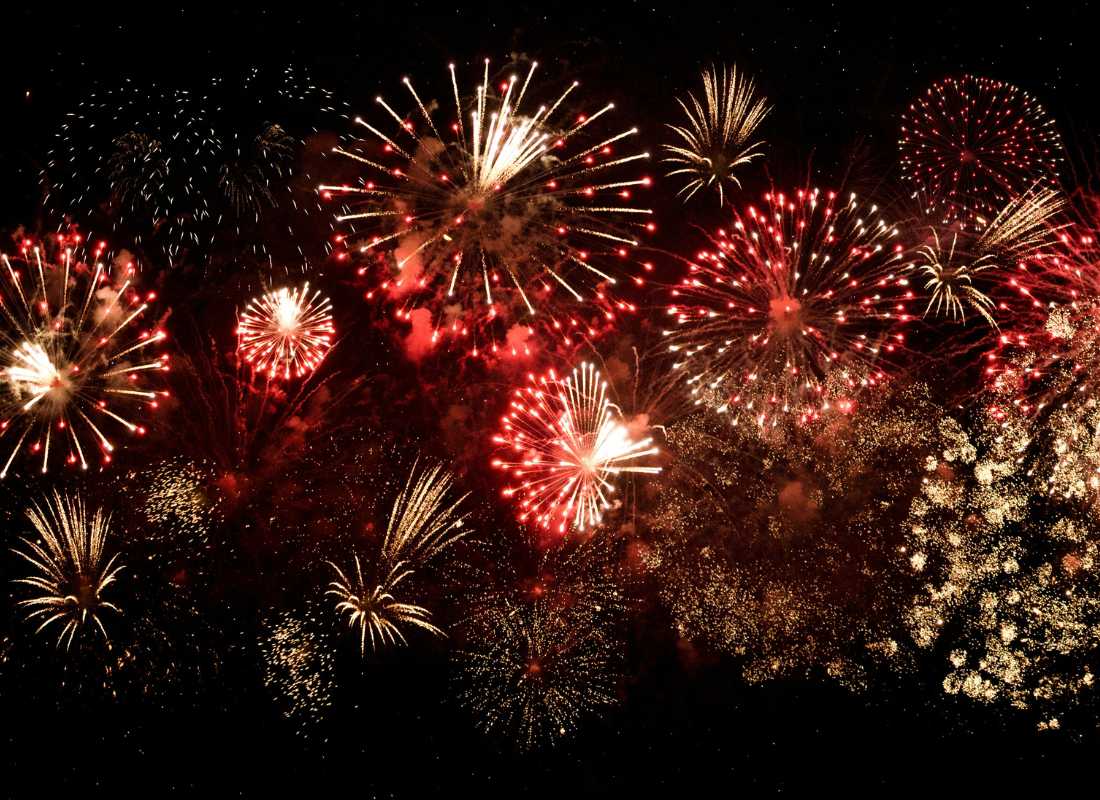 Red and gold fireworks exploding in the night sky