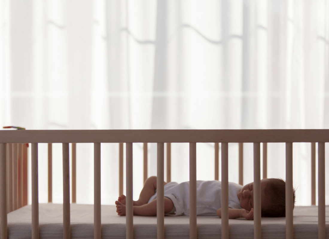 Baby sleeping in cot